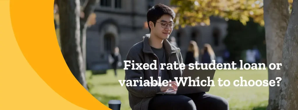 A student on campus reading on a laptop.