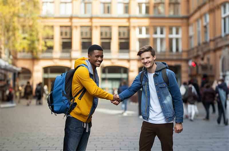 two-guys-shaking-hands-on-campus